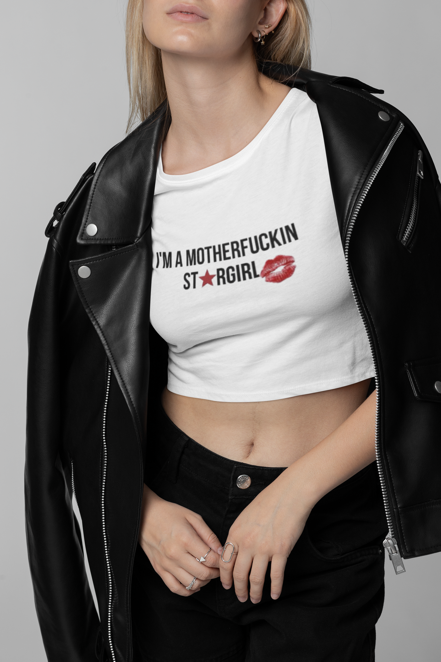 Closeup of white crop top with kiss print and bold text – women’s streetwear fashion