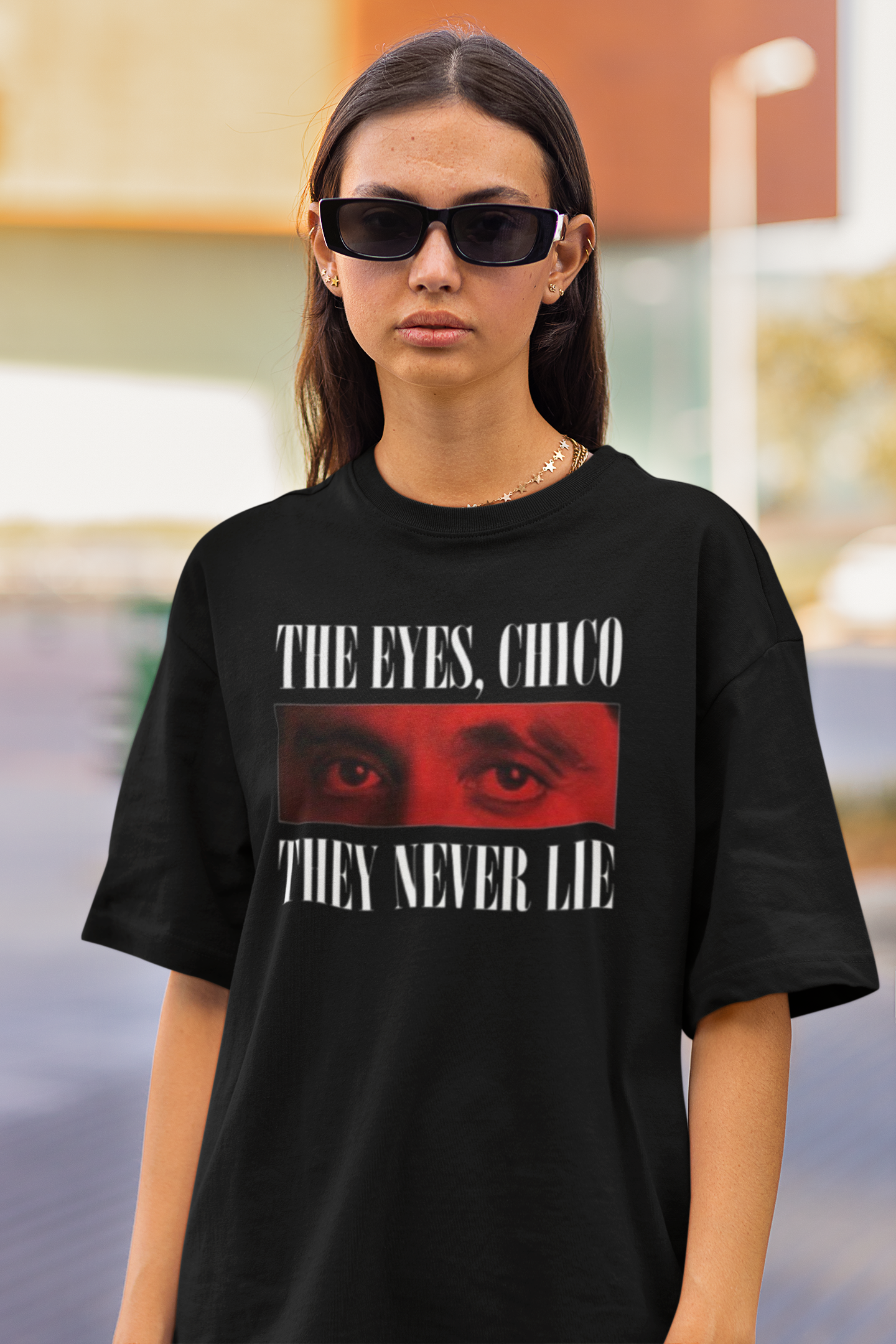 Model wearing oversized 240 GSM black t-shirt with The Weeknd's eyes and the quote 'The Eyes, Chico. They Never Lie.