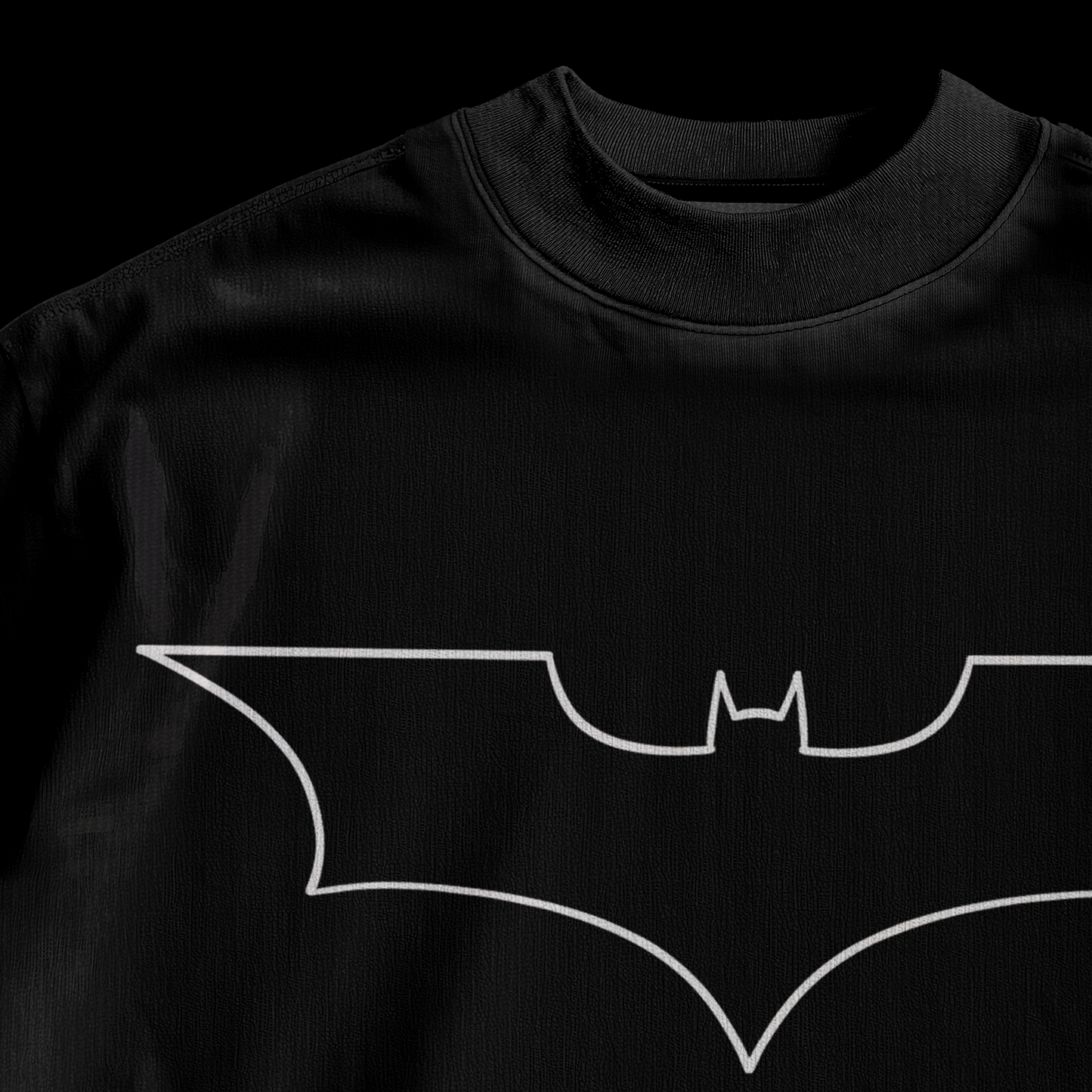 Close-up of white outline Batman logo print on amhype black drop shoulder oversized tee front