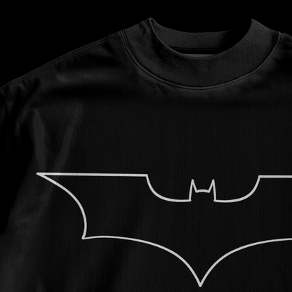 Close-up of white outline Batman logo print on amhype black drop shoulder oversized tee front