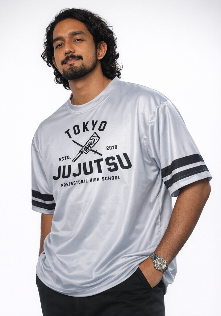 Person wearing a 'Tokyo JuJutsu' t-shirt with black stripes on sleeves against a white background