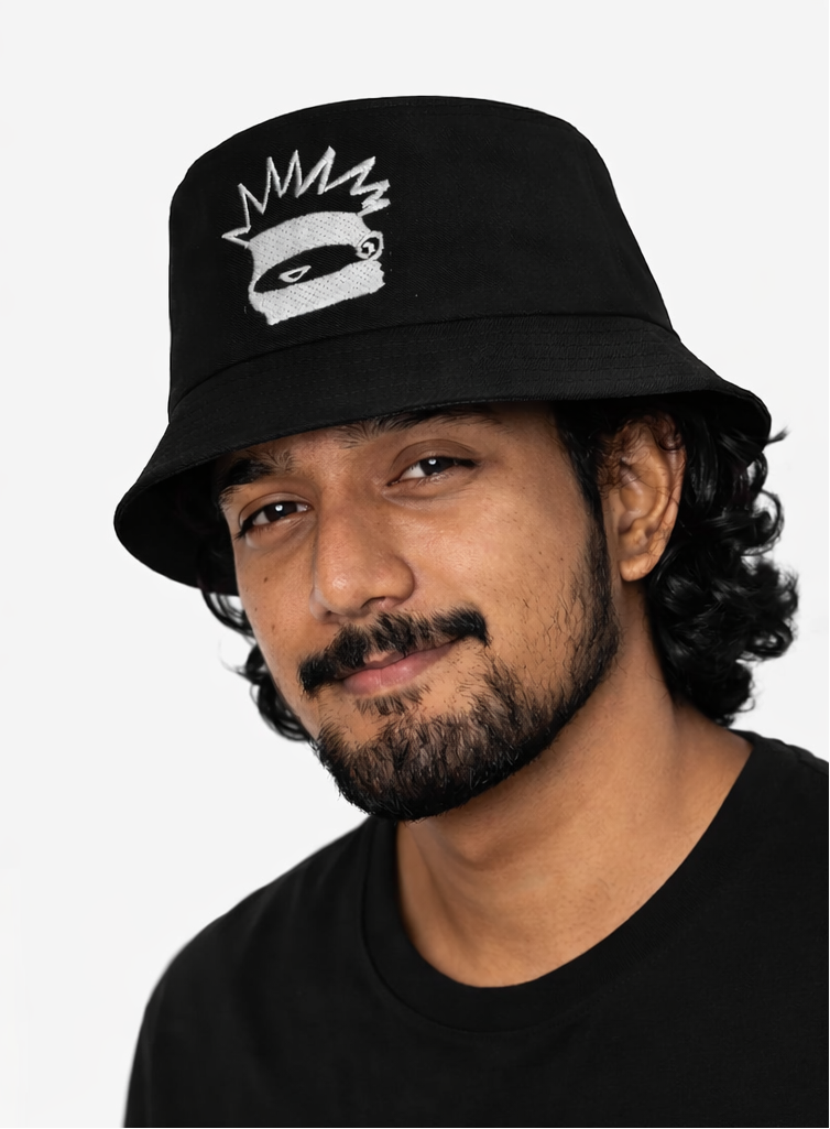 image of a man wearing a black bucket hat with a white logo on a white background